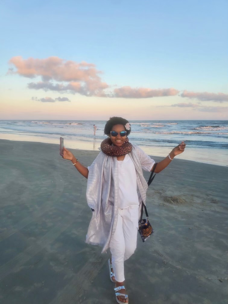 Dr. Stephanie Jupiter walking on the beach at sunset